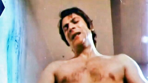 Sweaty hairy-chested man moaning in intense orgasmic ecstasy during rough sex