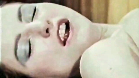 Vintage brunette's ecstatic face with open mouth and teeth bared in orgasmic moan