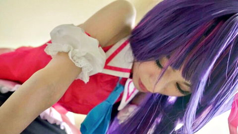 Seductive purple-haired Asian cosplay girl in frilly red maid outfit with sultry gaze