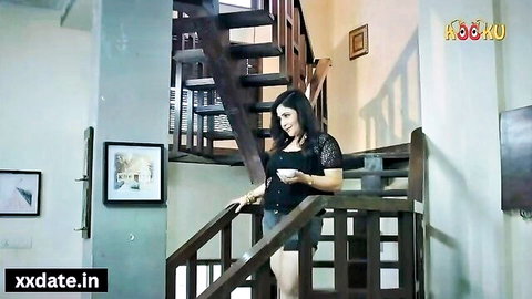 Curvy brunette in tight black top and short denim shorts teasing big tits on wooden stairs