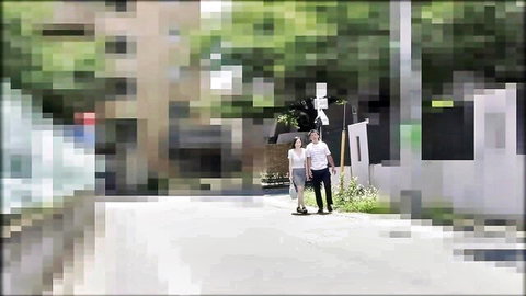 Japanese MILF in white skirt walking with man on urban street teasing