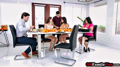 Brunette stepsisters in tiny white and pink dresses eat breakfast with stepbrothers at table showing legs and cleavage