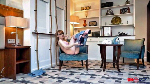 Sarah Sparks nude in chair, legs up inviting toy play