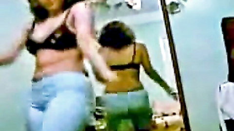 Bootylicious Arab girlfriend from Iraq in sexy dance with friend, showing curves in bra and jeans
