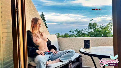 Blonde big tits babe sits topless on balcony exposing bare breasts and nipples outdoors