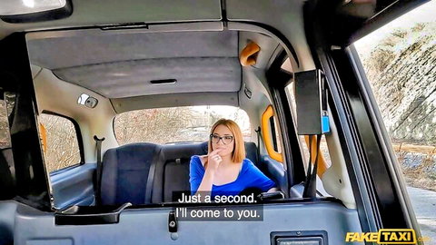 Blonde with glasses smokes cigarette in FakeTaxi cab teasing she'll come to you