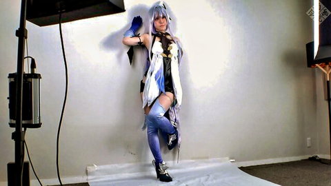 Cosplay beauty in revealing white-blue outfit with thigh-high stockings posing seductively