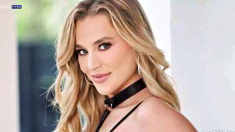 Seductive blonde with huge tits and black choker harness teasing cleavage