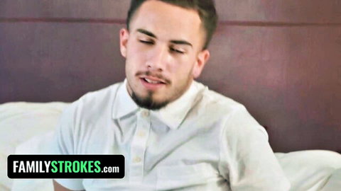 Young Latino guy in white shirt on bed, Family Strokes stepfamily scene