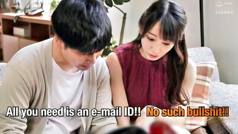 Asian brunette woman in maroon top sits with man on couch looking concerned at screen