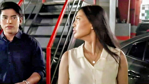 Asian couple in tense flirtation, man in shirt gazing at elegant woman in blouse