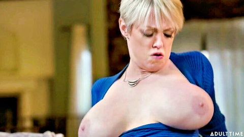 Blonde MILF with huge tits exposing breasts in open blue sweater