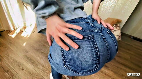 Sexy girl grabbing and spreading her big round ass in tight blue jeans from behind