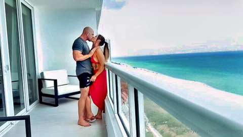 Kelsi Monroe passionately kissing muscular lover on balcony