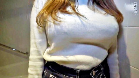 Busty amateur Japanese woman teases with huge tits and hard nipples poking through tight white sweater in bathroom