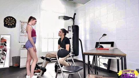 Petite brunette teen in tight shorts teases smiling coach in gym
