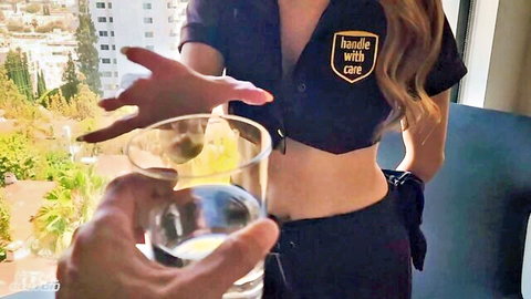 Busty blonde waitress in tight Handle with Care uniform pushes away glass of yellow liquid exposing deep natural tit cleavage