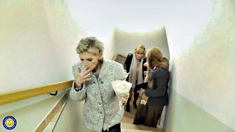 Blonde MILF Angelica and friends in coats on staircase, teaser for FFFM homemade sex