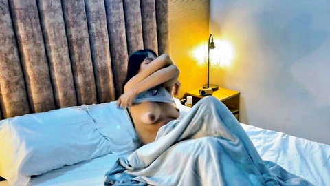 Saraymike exposes perky tits while teasing on bed