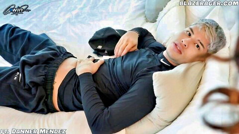Win Mendez in Nike tracksuit lying on bed, hand on abs teasing