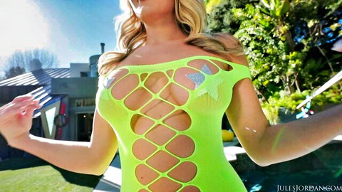 Stunning blonde in revealing green fishnet lingerie by the pool
