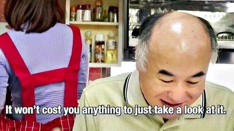 Satomi Suzuki in red apron teasing bald husband in JAV kitchen scene