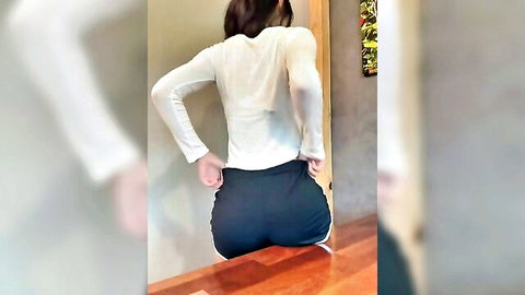 Korean sexy girl posing from behind in white top and tight black shorts