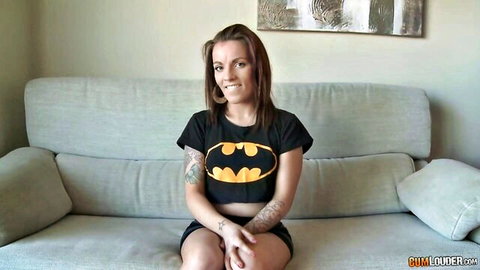 Nikita Bellucci smiling in Batman crop top and shorts, teasing pose