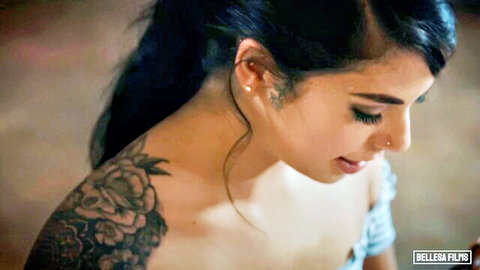 Gina Valentina as seductive horny secretary with rose tattoos, side profile in low-cut top