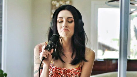 Brunette babe in floral top purses lips on microphone teasing blowjob with headphones