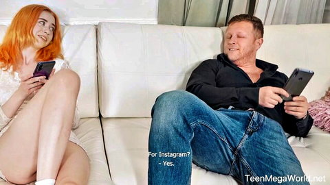 Redhead teen in sheer lace top spreads legs on couch with older man checking phones