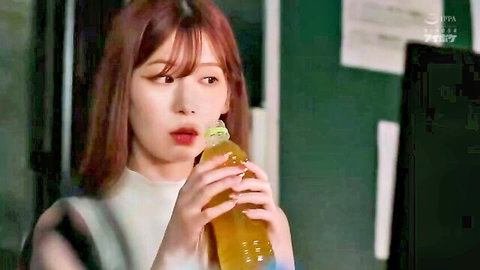 Cute Asian girl with puffy lips sucking on a thick yellow bottle spout teasingly