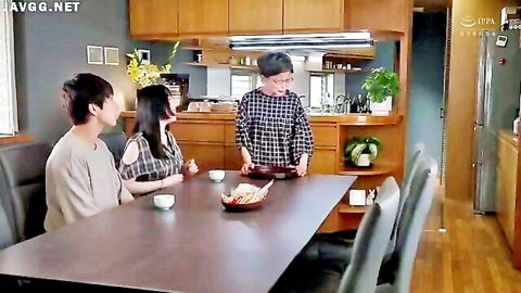 Japanese MILF housewife serves food at kitchen table with two men clothed teasing