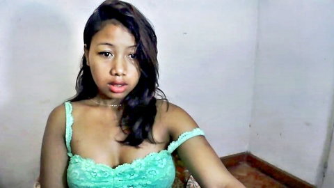 Smiling Malagasy woman in green lace lingerie showing cleavage
