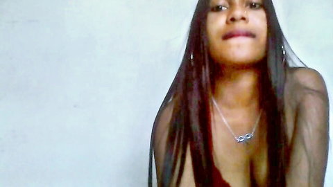 Stunning ebony Revy in low-cut red top with deep cleavage and long hair