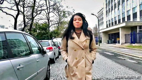 Sexy ebony woman in beige trench coat walking seductively on French street