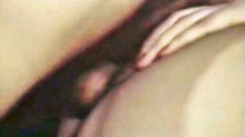Vintage Tabu Film close-up: woman's hand gripping cock near thigh