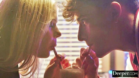 Blonde babe and curly-haired guy teasingly sucking pencils together in intimate closeup foreplay