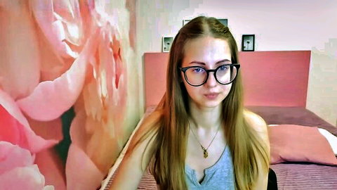 Kristina Adel blonde camgirl with glasses in tank top on MyFreeCams