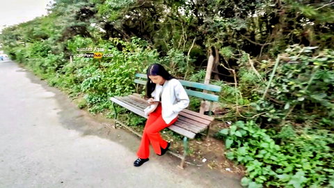 Indian gf in red pants and white jacket sits on park bench, Hunter Asia video thumbnail