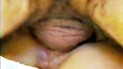 Extreme close-up of woman's spread open wet pussy exposing pink vaginal entrance and labia