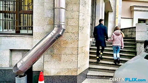 Bella Gray nerdy teen in pink jacket holds man's hand outdoors, teasing encounter