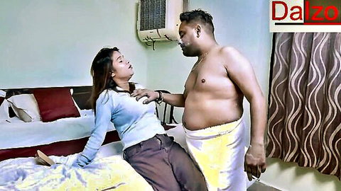 Indian man gropes woman's tits over clothes in hotel room foreplay