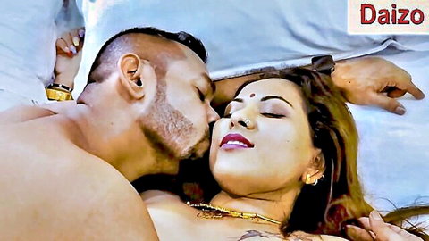 Indian hotwife kissing muscular man in bed, passionate foreplay