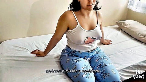 Curvy Latina MILF in tight tank top and pajama pants sitting on bed