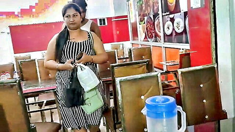 Doyel in black-white striped dress holding bags at eatery for birthday treat