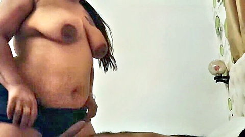 Curvy Asian woman topless in black panties during intimate honeymoon moment