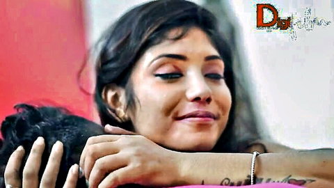 Smiling South Asian beauty intimately hugged from behind by boyfriend in closeup
