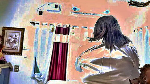 Seductive woman in sheer white blouse viewed from behind, long hair cascading