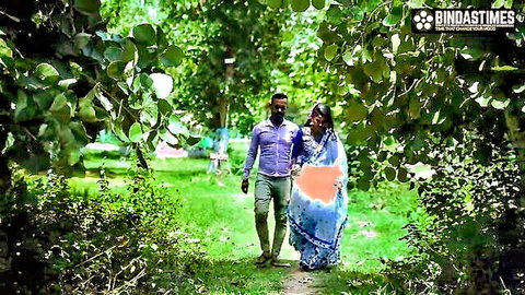 Desi couple in saree and shirt walking intimately in green park, threesome tease
